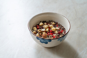 Healty Oatmeal Porridge with Brazil nuts, Cacao Chocolate Nibs, Pomegranate and Chia Seeds.