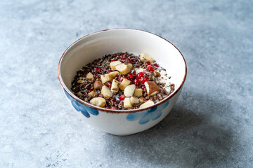 Healty Oatmeal Porridge with Brazil nuts, Cacao Chocolate Nibs, Pomegranate and Chia Seeds.