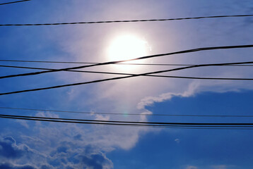 the sun was shining down on the power lines and telephone cables