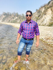 Handsome model man wearing colorful t-shirt with kosi river mountain beautiful background