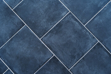 Ceramic tiles in a square shape in shades of blue. Flat lay of the frame. Large items