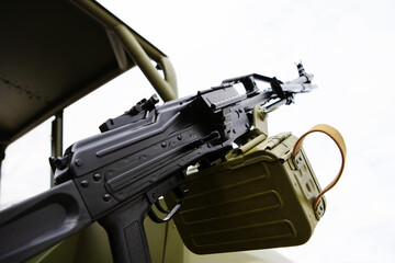 Machine gun and ammunition on a military vehicle. Combat artillery firearms. Close-up. Bottom up view