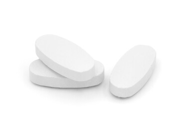 Closeup three white pills isolated on white background