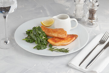 Grilled salmon slice on a bed of blanched spinach