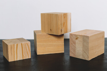 Natural mockup of wooden cubes for cosmetics on black and white background.