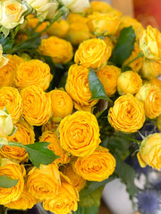 Background image of bright yellow peony-shaped bush roses, a bouquet of beautiful flowers for a gift