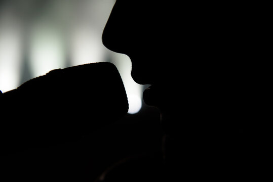 Singer in silhouette. Close up image of live singer on stage