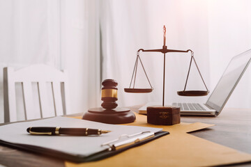 Justice and law concept.Male judge in a courtroom with the gavel, working with, computer and...