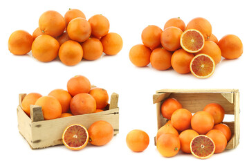 fresh blood oranges and some  in a wooden crate on a white background
