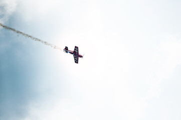 Red plane in the sky doing aerobatics