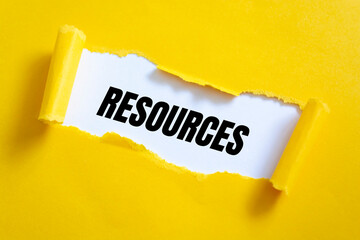 Torn yellow paper revealing the word Resources