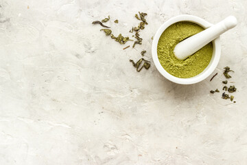 Henna powder in white mortar. Herbal natural hair dye