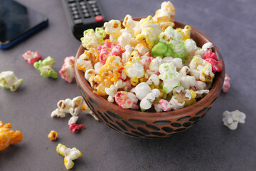 high angle view of popcorn and Tv remote on table 