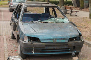 burned and wrecked car in the parking lot