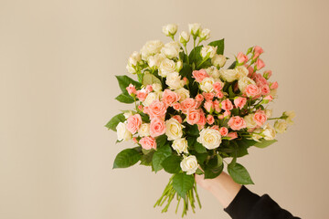 Bouquet of pink roses in female hands