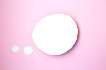 White paper speech bubble concept. Cartoon speech with clipping path in the form of a circle on bright pink background with contrasting shadow