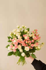 Bouquet of small roses in female hands