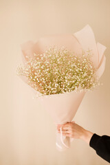 bouquet of small white flowers of Gypsophila Paniculata in female hands