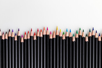 Collection of multicolored pencils on a white background.