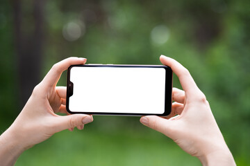 Man holding smart phone with blurred background. For Graphic display montage.