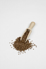 a handful of flax seeds on a white table 