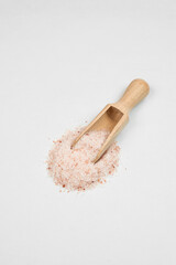 a handful of pink salt on a white table 