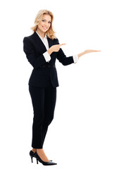 Happy smiling young businesswoman, showing something or blank copy space area for slogan or text message, isolated over white background. Full body portrait of business woman at studio.