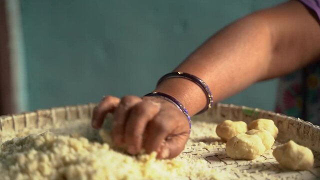 Woman making thekua by hand for chhath puja