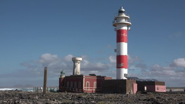 Lighthouse. Old red lighthouse. Blue sea background. Navigation equipment on the ocean.