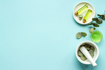 Essential oil in glass bottle, herbs with eucalyptus. Space for text