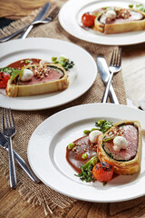 Easter meat roll, meatloaf for Easter dinner. Beautifully decorated catering banquet table with different food snacks and appetizers