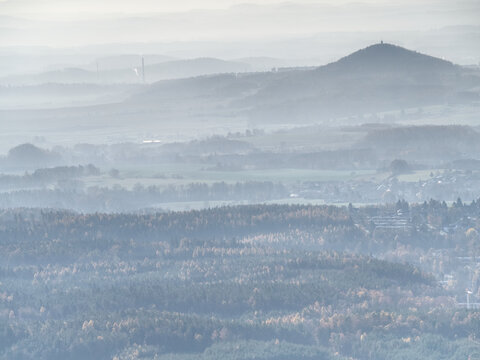 Blue Mist Above Rounded Hills In Landscape. Outline Of Real Landscape In Morning Golden Light.