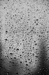 Raindrops on window pane on a cold day of winter