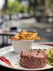 Fresh steak tartare with salad and French fries