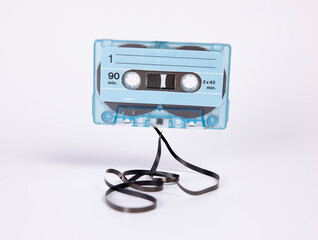 A blue cassette with magnetic tape on floor