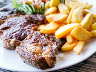 Juicy steak, beef meat with tomato and french fries