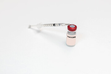 Obraz premium selective focus of a Vaccine and a syringe on a white background as a remedy to the disease viruses and Covid19 in health concept