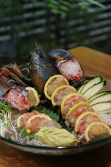 Japanese Menu - Lobster Sashimi in the glass plate served with lemon and cucumber