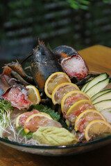 Japanese Menu - Lobster Sashimi in the glass plate served with lemon and cucumber