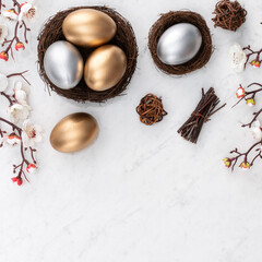 Design concept of Golden and silver Easter eggs in the nest with white plum flower.