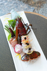 Japanese Menu - Lobster Sashimi in the glass plate served with lemon and cucumber
