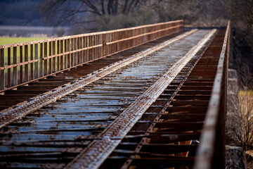 Fototapeta premium A closed railway bridge in Skwierzyna. Close-ups on the bridge structure. Picture taken in the early afternoon, sunny weather
