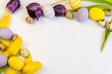 Congratulatory Easter background. Tulips and easter eggs on white   background. Happy easter.  Top view. Copy space. Easter holiday greeting card.