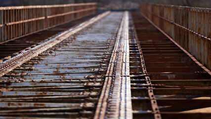 Fototapeta na wymiar A closed railway bridge in Skwierzyna. Close-ups on the bridge structure. Picture taken in the early afternoon, sunny weather