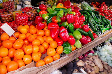 Market with vegetables and fruits. Oranges, tomatoes, bell peppers, potatoes, radishes, garlic. Farm vegetables