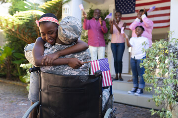 African american soldier father in wheelchair hugging daughter three generation family behind