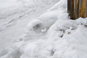 White snow and ice after drop. Signs of spring