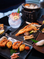 Fototapeta na wymiar Japanese Menu - Variety of Japanese food - Fish hotpot, Grilled River prawn, Seafood Teppanyaki, Gyudon, Shrimp Skewer and Suzuki Sashimi