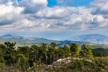 Summer landscape. Blue sky with clouds over the mountain ridge in the distance.