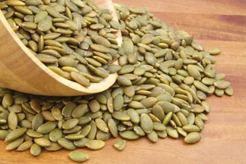 Pumpkin seed in wooden bowl and on wooden table